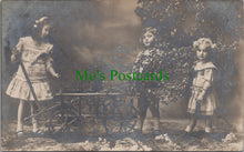 Load image into Gallery viewer, Children Postcard - Three Children With a Hand Cart and a Tree SW12703
