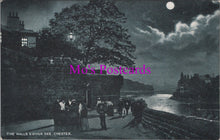 Load image into Gallery viewer, Vintage black and white postcard of a moonlit scene by a river with people on a bridge.