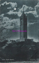 Load image into Gallery viewer, Vintage black and white postcard of a clock tower under a moonlit sky with 'Mrs. Postcards' watermark.