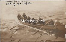 Load image into Gallery viewer, Vintage postcard of a group in a rowboat on water with text 'Whaler from Violent picking up a torpedo.'
