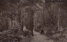Load image into Gallery viewer, Vintage black and white photograph of a person sitting on a bench in a forested area with 'Pine Walk, Folkestone' text.