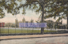 Load image into Gallery viewer, Vintage postcard of a castle-like building with trees and grass in the foreground.