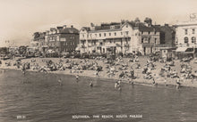 Load image into Gallery viewer, Vintage black and white photo of a beach scene with people and buildings.