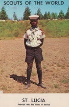 Load image into Gallery viewer, Scout in uniform standing in a field with 'Scouts of the World' and 'St. Lucia' text at the top.
