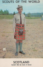 Load image into Gallery viewer, Scout in uniform with a kilt standing outdoors, with 'Scouts of the World' and 'Scotland' text at the top.