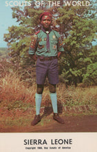 Load image into Gallery viewer, Scout in Sierra Leone wearing a uniform with a tree in the background