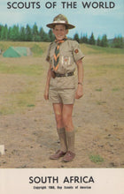 Load image into Gallery viewer, Scout in uniform standing outdoors with trees and tents in the background, labeled 'Scouts of the World, South Africa'.