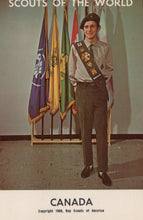 Load image into Gallery viewer, Scout standing in front of flags with 'Scouts of the World' and 'Canada' text.