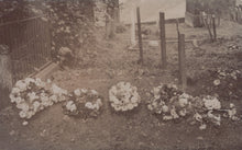 Load image into Gallery viewer, Vintage black and white photo of a cemetery with floral wreaths and gravestones.