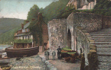 Load image into Gallery viewer, Vintage postcard of a coastal scene with a boat, building, and people near a stone wall.