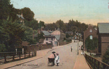 Load image into Gallery viewer, Vintage postcard of a street scene with people and a baby carriage in a residential area.