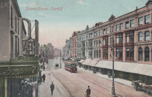 Load image into Gallery viewer, Vintage postcard of Queen Street, Cardiff with tram and pedestrians.