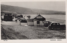 Load image into Gallery viewer, Vintage black and white photo of a beach promenade with huts and cars, featuring 'National Caravan' branding.