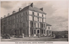 Load image into Gallery viewer, Vintage black and white photo of a large building labeled 'Four Oaks Private Hotel, Central Promenade, Llandudno'.