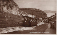Load image into Gallery viewer, Vintage photograph of a tram on tracks with a scenic background
