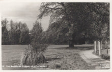 Load image into Gallery viewer, Black and white photo of a park with trees and a path, labeled 'The Recreation Ground, Leatherhead'.