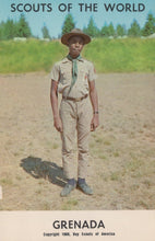 Load image into Gallery viewer, Scout in uniform standing in a field with 'Scouts of the World Grenada' text at the top.