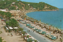 Load image into Gallery viewer, Vintage postcard of a coastal scene with cars, palm trees, and a beach.