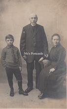 Load image into Gallery viewer, Vintage black and white photo of a family posing together with 'Mo's Postcards' text.