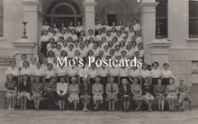 Load image into Gallery viewer, Black and white group photo of people in front of a building