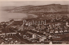 Load image into Gallery viewer, Vintage black and white postcard of Colwyn Bay from Bryn Eirth, showing coastal view with buildings and sea.