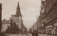 Load image into Gallery viewer, Vintage black and white photograph of a city street with tall buildings and a clock tower