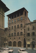 Load image into Gallery viewer, Historic building with architectural details in an urban setting