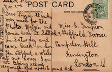 Load image into Gallery viewer, Vintage postcard with handwritten text and a stamp, featuring a brown background.