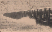 Load image into Gallery viewer, Vintage postcard of a stormy sea with a pier, featuring handwritten text.