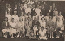 Load image into Gallery viewer, Black and white group photo of people with tennis rackets on a tennis court