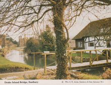 Load image into Gallery viewer, Bridge over a river with a house and trees in the background at Drake Island Bridge, Eastbury.