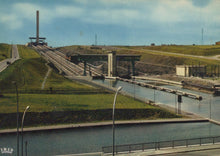 Load image into Gallery viewer, Historical photograph of a canal lock system with grassy area and road in the foreground.