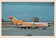 Load image into Gallery viewer, Vintage airplane on a runway with a clear sky background