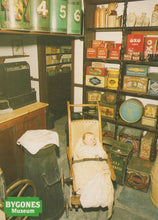 Load image into Gallery viewer, Vintage display with baby in pram and various historical products at Bygones Museum.