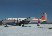 Load image into Gallery viewer, Vintage airplane with 'Trans Air' branding on a snowy ground
