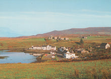 Load image into Gallery viewer, Scenic view of a village by a lake with mountains in the background