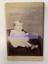Load image into Gallery viewer, Vintage photograph of a child sitting on a chair with 'Mo's Postcards' watermark.