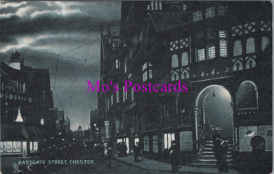 Vintage black and white postcard of Eastgate Street, Chester with a dark sky.