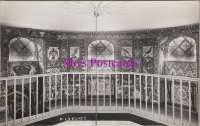 Decorative interior with intricate wall patterns and a railing, featuring 'Mo's Postcards' text.