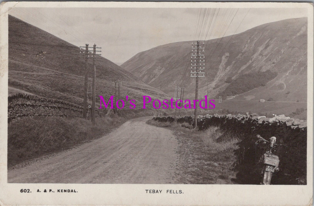 Vintage black and white photo of a mountainous landscape with a road and telephone poles, labeled 'Mo's Postcards'.