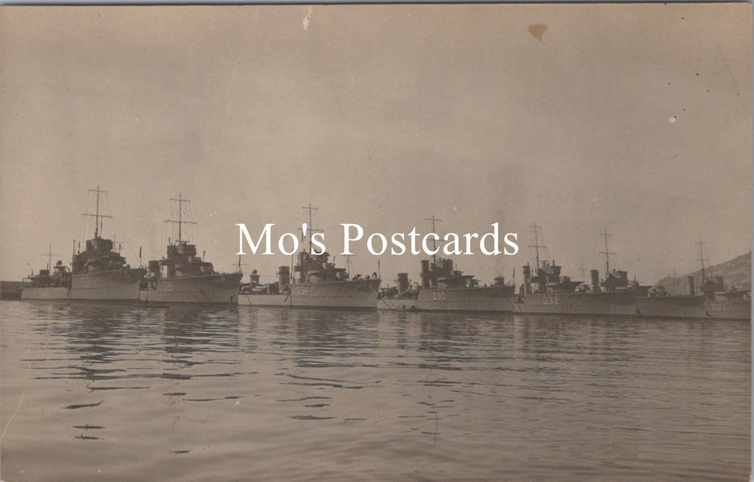 Vintage black and white photograph of naval ships docked at a harbor 