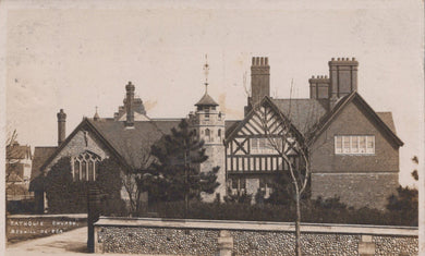 Historic black and white photograph of a church with a prominent tower and architectural details.