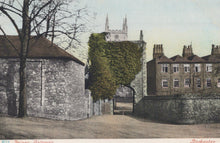 Load image into Gallery viewer, Vintage colorized postcard of a street scene with buildings and a church spire.
