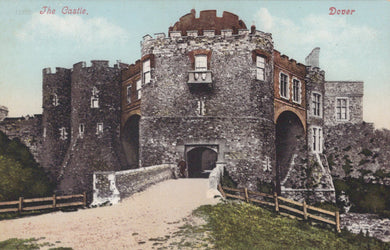 Colorized postcard of a castle with a woman walking towards it, labeled 'Dover Castle'.