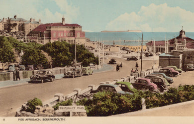 Vintage colorized photograph of a coastal scene with cars and buildings, likely from Bournemouth.