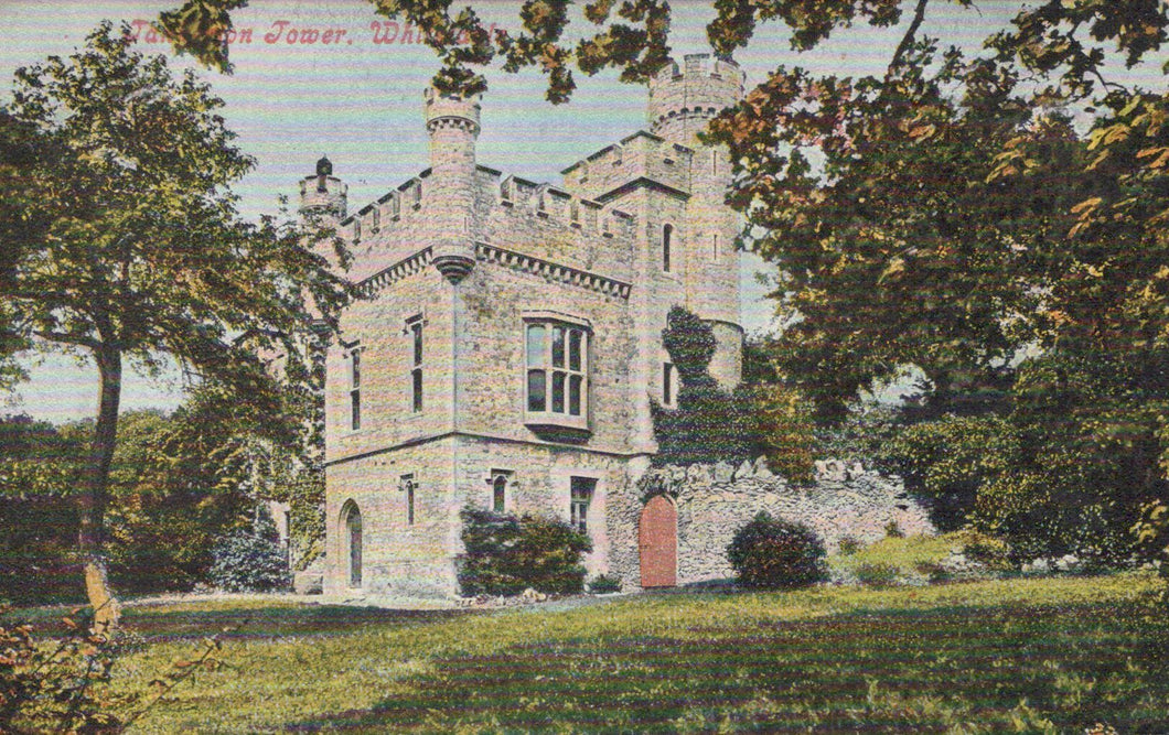 Stone tower with decorative architecture in a park-like setting
