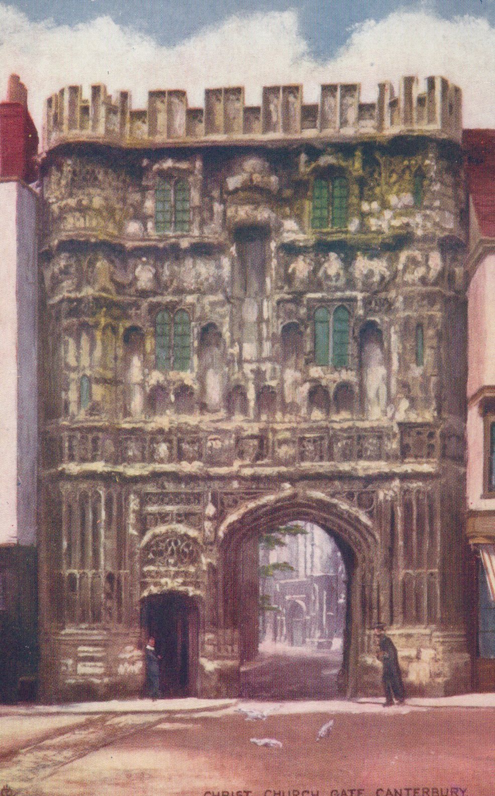 Historic stone gate with decorative elements in a cityscape