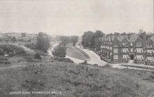Load image into Gallery viewer, Vintage black and white photograph of a residential area with houses and a road.

