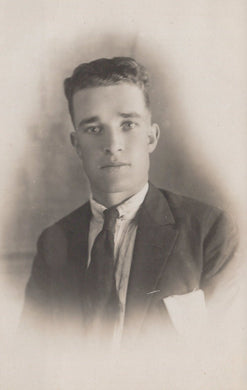 Vintage black and white portrait of a man in formal attire.