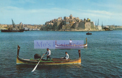 Two gondoliers in a gondola on a body of water with a castle in the background.